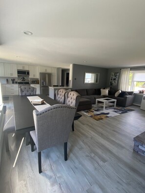 Enjoy a spacious living area with a large dining table and comfortable seating.