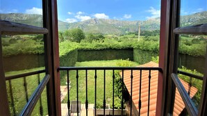 Un balcone con vista su un paesaggio verde e montagne.