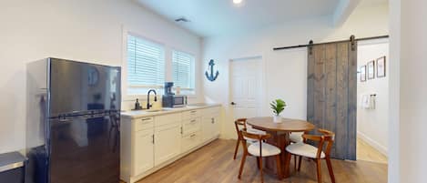 Full-size fridge, microwave, stovetop, cookware/dishes/utensils