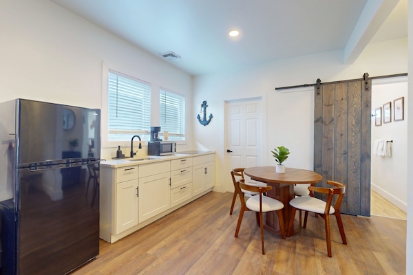 Full-size fridge, microwave, stovetop, cookware/dishes/utensils