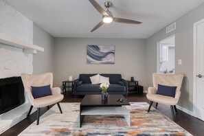 TV connectée, cheminée, livres, enceintes connectées