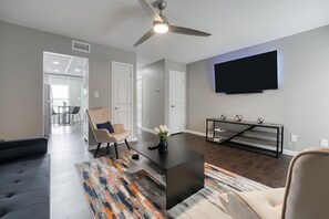 Smart TV, fireplace, books, smart speakers
