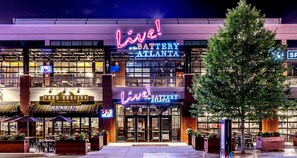 A building with a neon sign reading "Live! Battery Atlanta" and another sign for "Todd English at the Tavern". - Emerald Suite near Truist Park / Free Parking (Atlanta)
