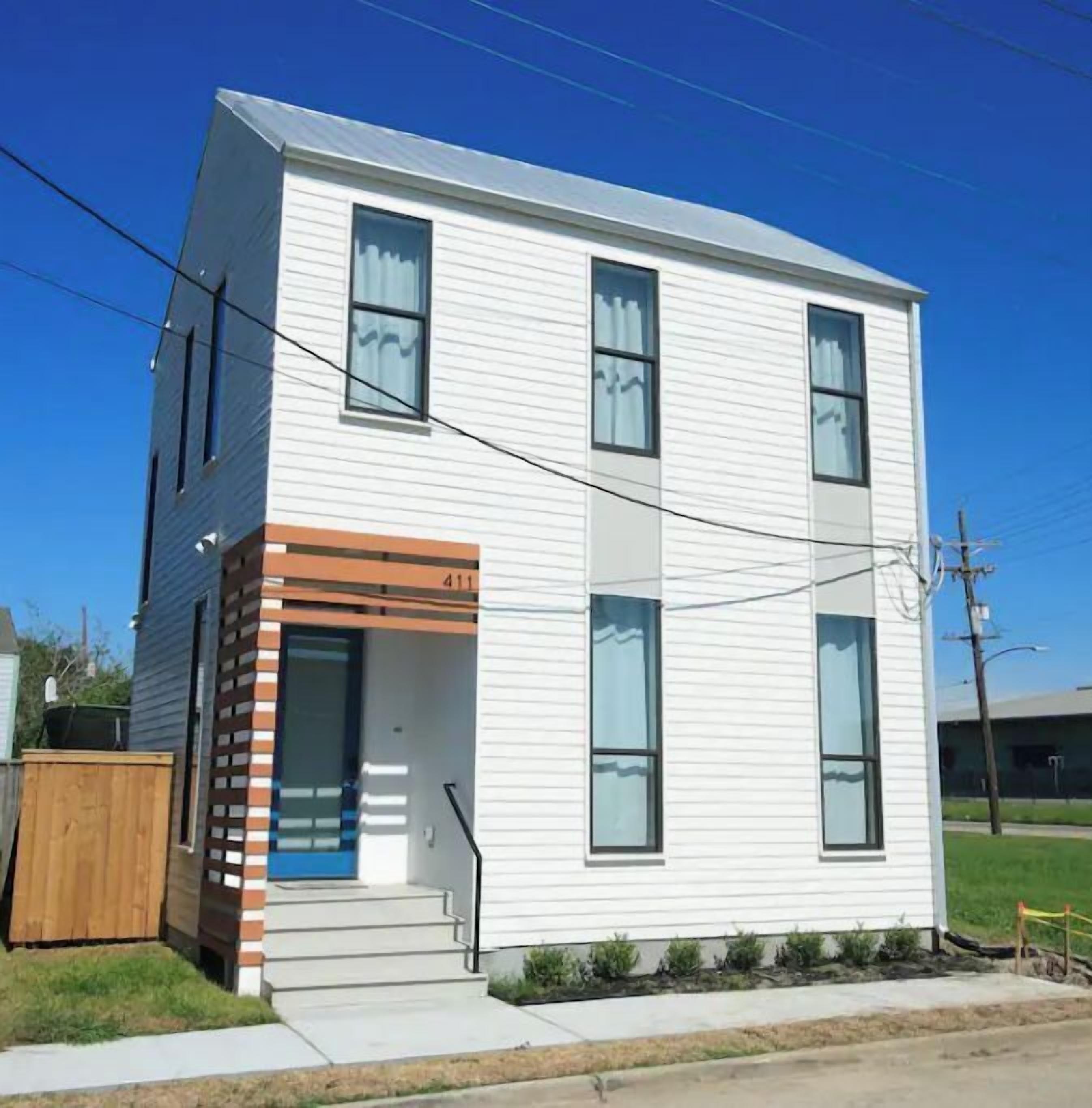 A two-story building with a flat roof, large windows, and a visible address number 411.