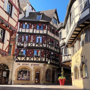 A traditional half-timbered building with a shop at the ground level.