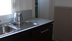 A kitchen with a stainless steel sink, a coffee maker, and a window. - APARTMENT GÎTE DE L'OBERHARTH COLMAR ALSACE (Colmar)