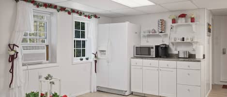 Fridge, microwave, coffee/tea maker, cookware/dishes/utensils