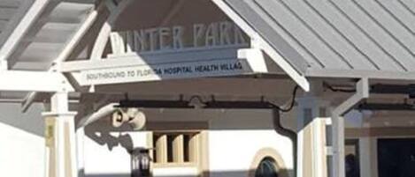 A building with a sign reading "INTER PARK" and "NORTHBOUND TO FLORIDA HOSPITAL HEALTH VILLAGE".