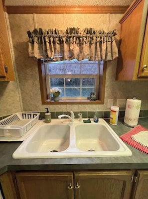 Enjoy cooking in this well-equipped kitchen with a double sink and ample counter space.