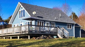 A two-story house with a balcony, a satellite dish, and a deck area. - Secluded Chalet in the Northern Catskills with FIBER Internet and EV hookup (Summit)