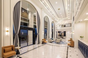 A spacious lobby with a marble floor, large arched windows, and modern lighting fixtures. - Eastin Hotel Vientiane Laos (Vientiane)