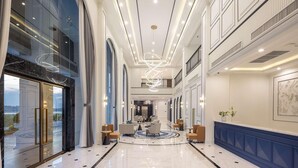 A spacious, elegantly designed hotel lobby with a high ceiling, large windows, and a central chandelier. - Eastin Hotel Vientiane Laos (Vientiane)