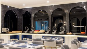 A modern restaurant with marble walls, multiple seating areas, and a bar counter with decorative items. - Eastin Hotel Vientiane Laos (Vientiane)