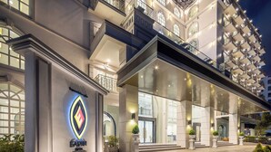 A grand hotel entrance with a prominent logo, large glass doors, and a well-lit facade. - Eastin Hotel Vientiane Laos (Vientiane)
