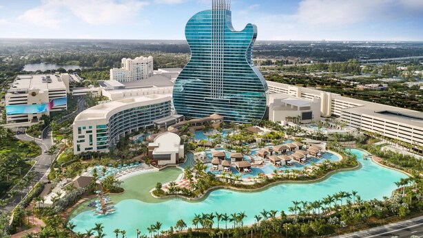 A resort with a large guitar-shaped building, multiple swimming pools, and lush landscaping. - Miramar Breeze (Miramar)