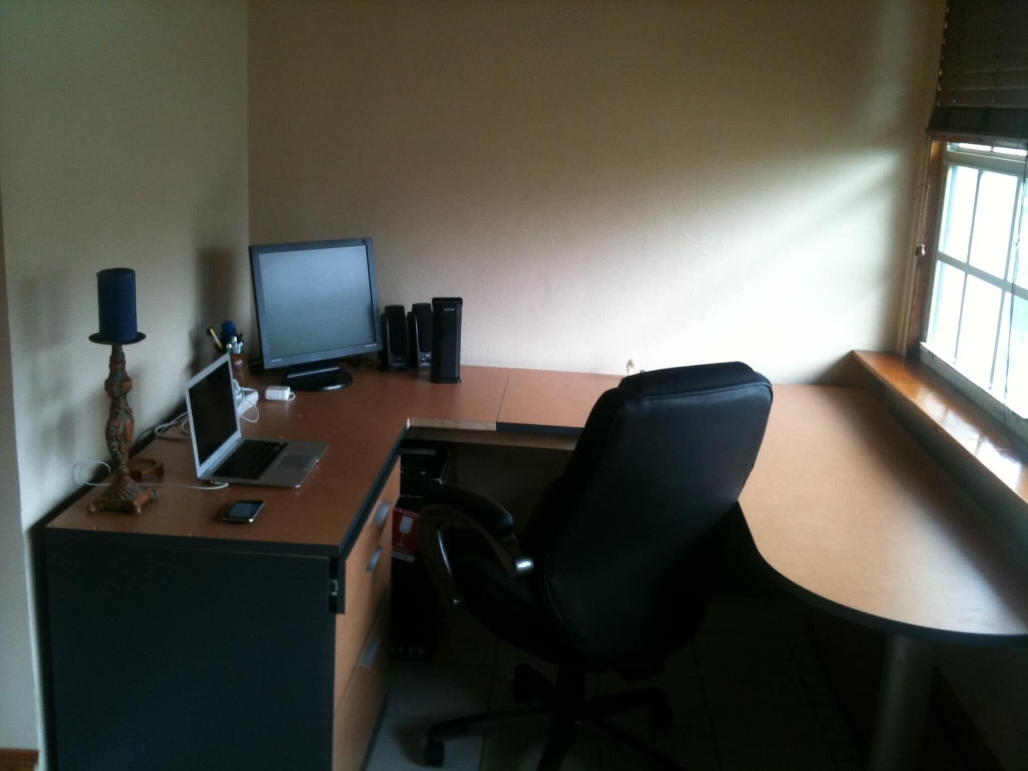 A home office with a desk, computer, and chair.