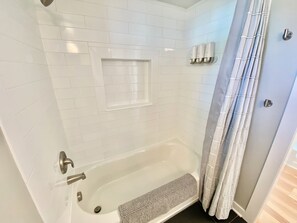 Bathtub, hair dryer, towels, soap