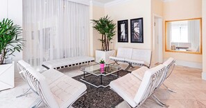 A modern living room with a sofa set, a coffee table, and a large mirror. - Manhattan Floor By 1/4 UmQuarto | Ao lado do Shopping Estação (Curitiba)