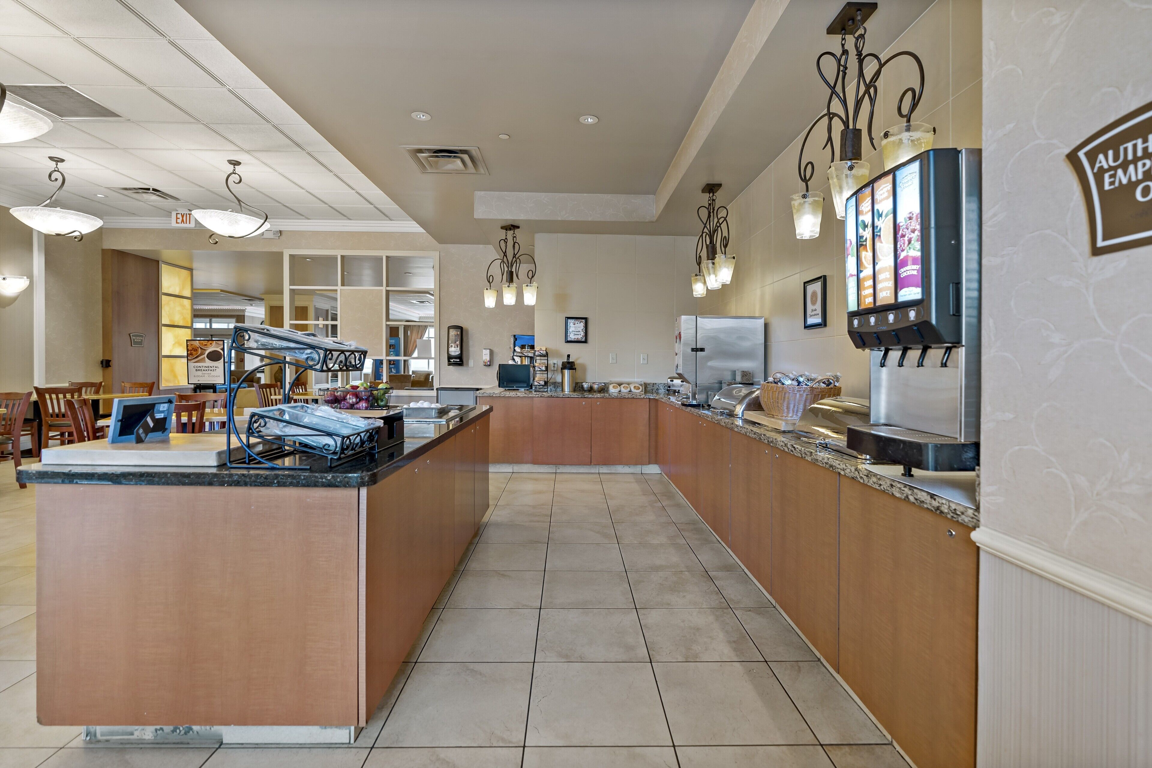 A spacious kitchen area with a central island, built-in appliances, and a coffee machine.