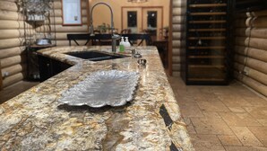 A kitchen with a granite countertop, a sink, and a built-in oven. - RAIN VALLEY RETREAT on 6 STUNNING acres! GAMES/GRILL/AC! (Flagstaff)