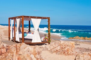 On the beach, white sand, beach umbrellas, beach massages