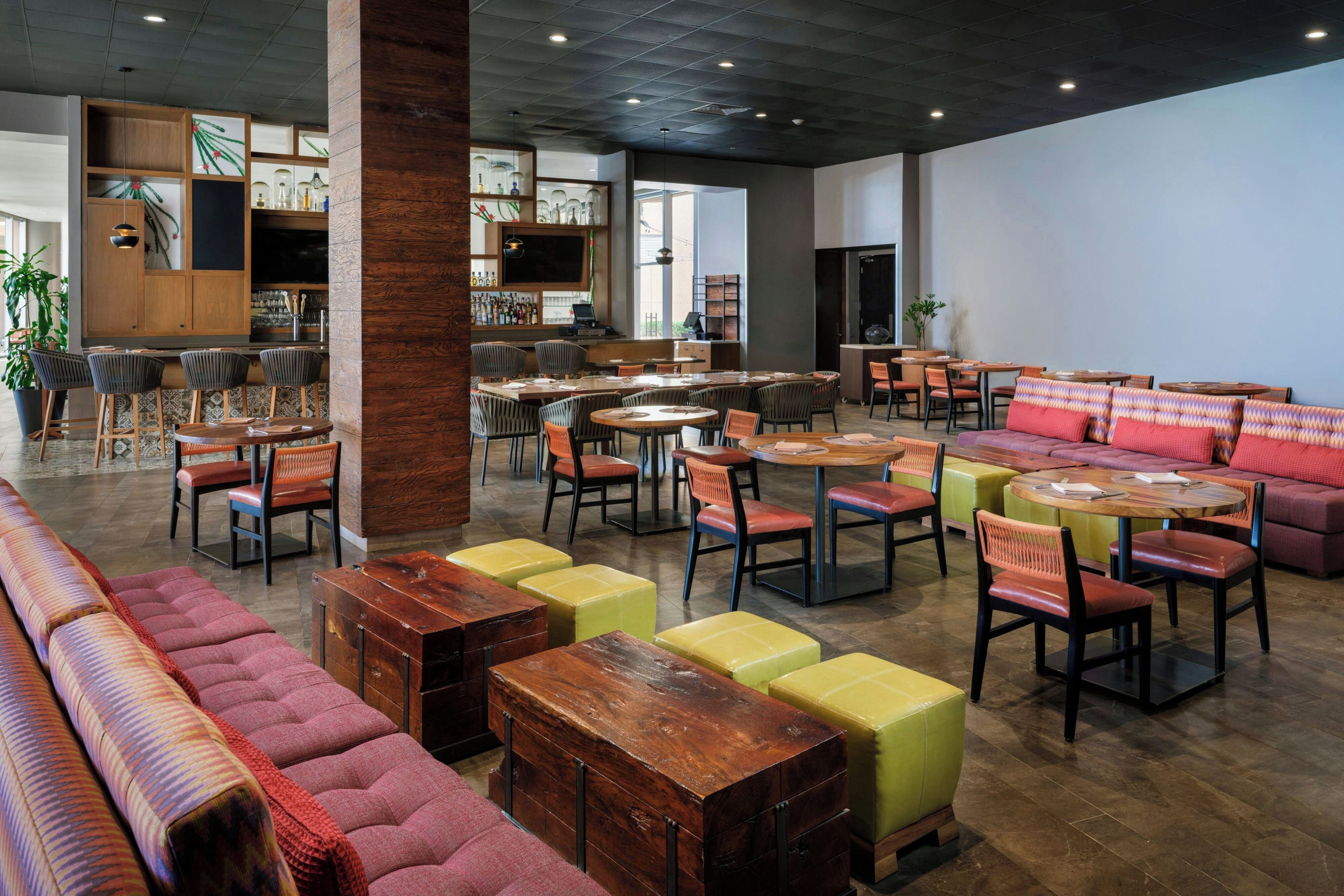 A spacious indoor area with multiple seating options including sofas, chairs, and tables.