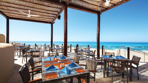 An outdoor dining area with tables and chairs, overlooking the ocean. - The Westin Los Cabos Resort Villas - Baja Point (San José del Cabo)