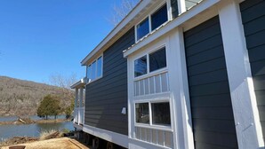 A two-story house with a dark siding exterior and white trim around the windows and roofline. - Hales Bar Marina and Resort (Guild)