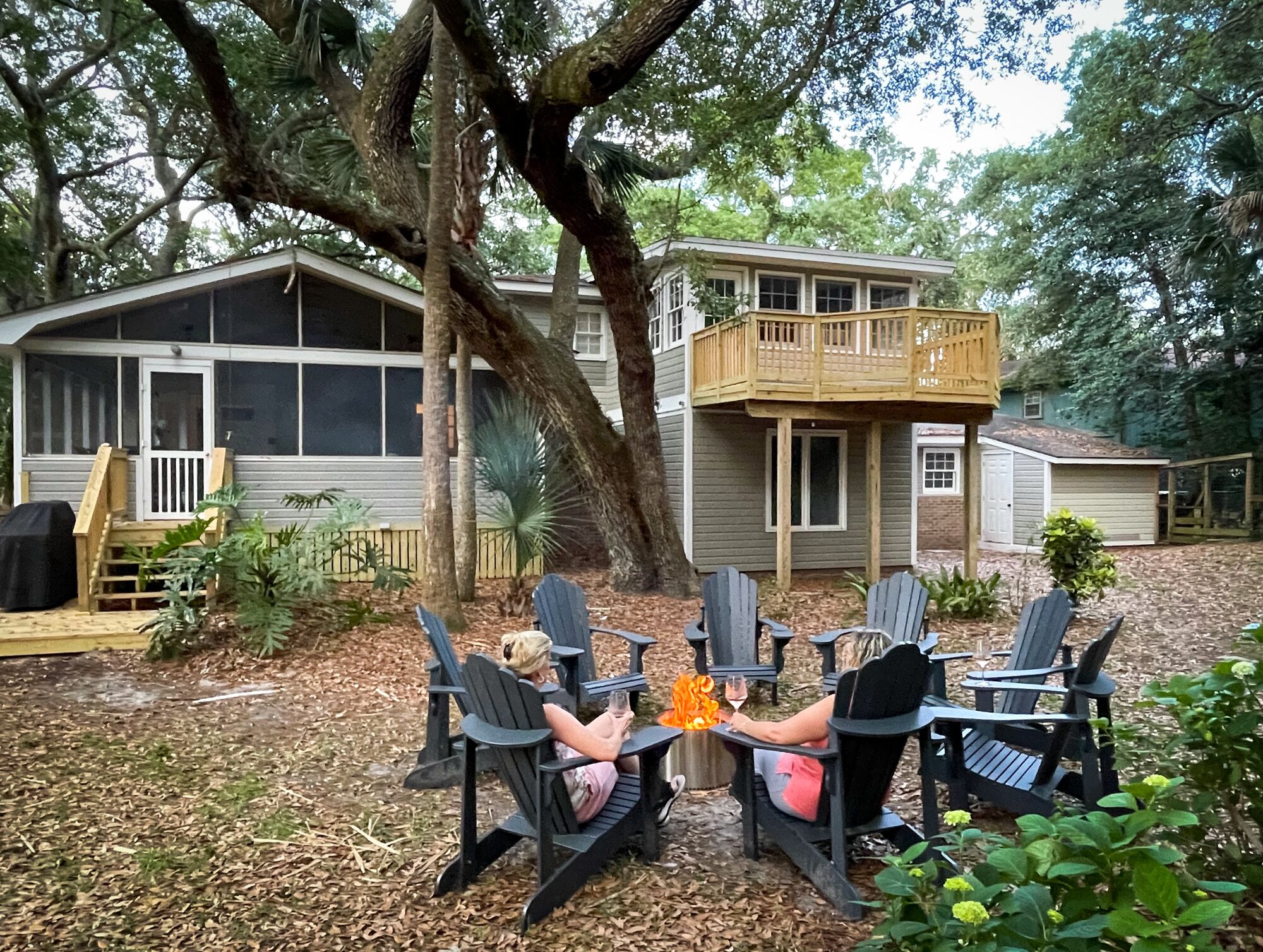 A house with a deck and outdoor seating area.