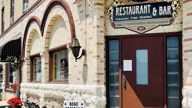 A building with a sign for Hotel Stebbins, Restaurant & Bar, and a sign for Bogo Cocktails on Fridays.