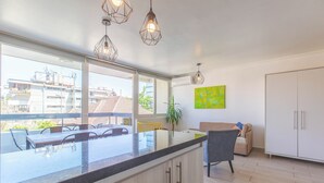 A modern kitchen with a large island, pendant lighting, and a view of the city. - Apartment - AC - Costanera Center - Metro - Providencia (santiago)