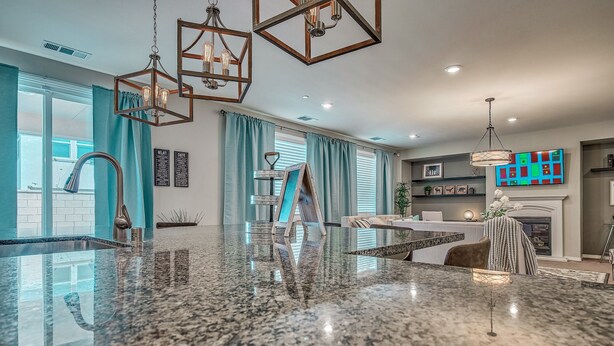 A modern kitchen with granite countertops, pendant lighting, and a large island. - 1000MBPS Wifi★One Story Luxury 5 Bedrooms Model Home (Jurupa Valley)
