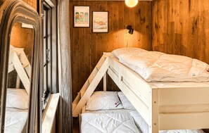 A compact room with a bunk bed, wooden walls, and a small window. - 5 bedroom nice home in Nexø (Nexø)