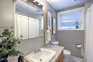 Bathtub, towels, soap, toilet paper