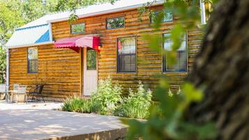 Relax in this charming cabin with a patio and comfortable outdoor seating.