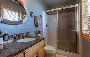 A bathroom with a marble countertop, two sinks, a toilet, and a glass-enclosed shower. - MAJESTIC VIEWS | Family Lodge | Large Deck (Star Valley Ranch)