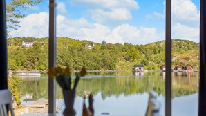 A lake with houses on the shore, a dock, and a clear sky. - 3 bedroom awesome home in Sveio (Sveio)