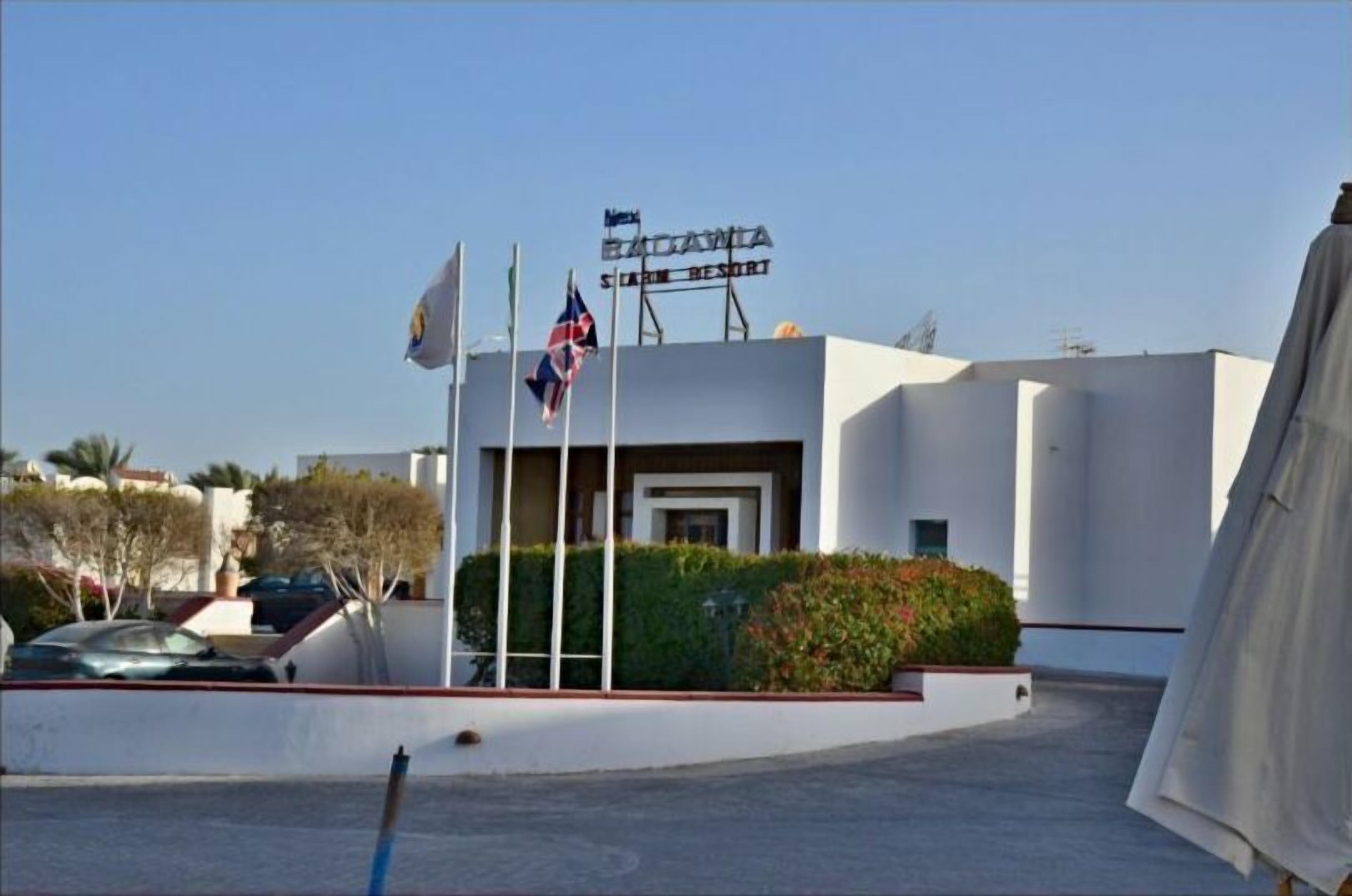 A modern building with a sign reading "BADAVIA SAILING RESORT".
