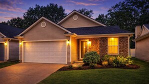 A single-story house with a garage, a brick entrance, and a well-maintained lawn. - Midnight Lexington Newly Remodeled Designer Stay (Lexington)