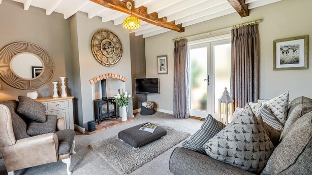 A cozy living room with a fireplace, comfortable seating, and a television. - Paddock Cottage - Thorpe Arnold, Melton Mowbray (Melton Mowbray)
