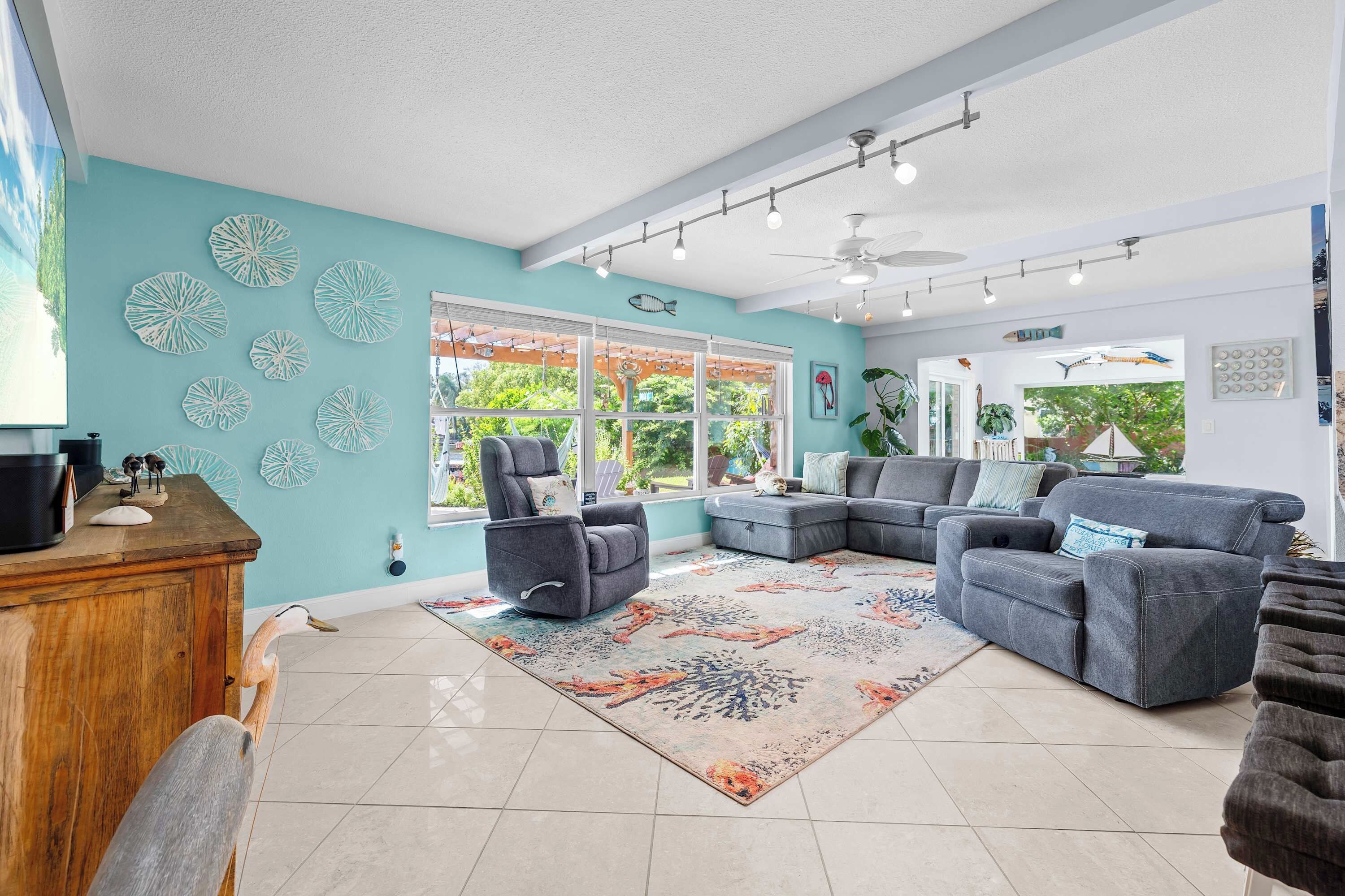The back family room, right off the kitchen, features electrically reclining furniture for ultimate comfort. The kitchen bar, with seating for four, makes it easy to chat with friends or family while enjoying a meal or a drink