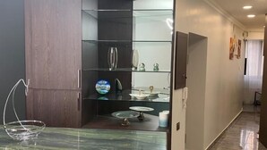 A modern kitchen with a marble countertop, a built-in wine rack, and a black chair. - Luxury2BED1Bath/central Yerevan Wi-Fi/2nd Floor/Demrtchyan40./ARMTRAVElTURE.com (YEREVAN)