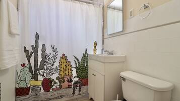 Bathtub, towels, soap, toilet paper