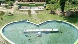A heart-shaped pool with the name "TAMAN NGGIRI" written across it. - Camping Ground Taman Nggirli (Srimulyo)