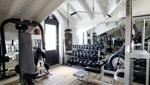 A gym with weightlifting equipment, a bench press, and a rack of dumbbells. - Villa Z’Abricot – Spacious Family Villa with Recreational Amenities Near Orient Bay, St. Martin (Cul-de-Sac)