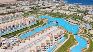 An aerial view of a resort with multiple swimming pools, beachfront villas, and a beach. - Xanadu Makadi Bay - High Class All Inclusive (Makadi Bay)
