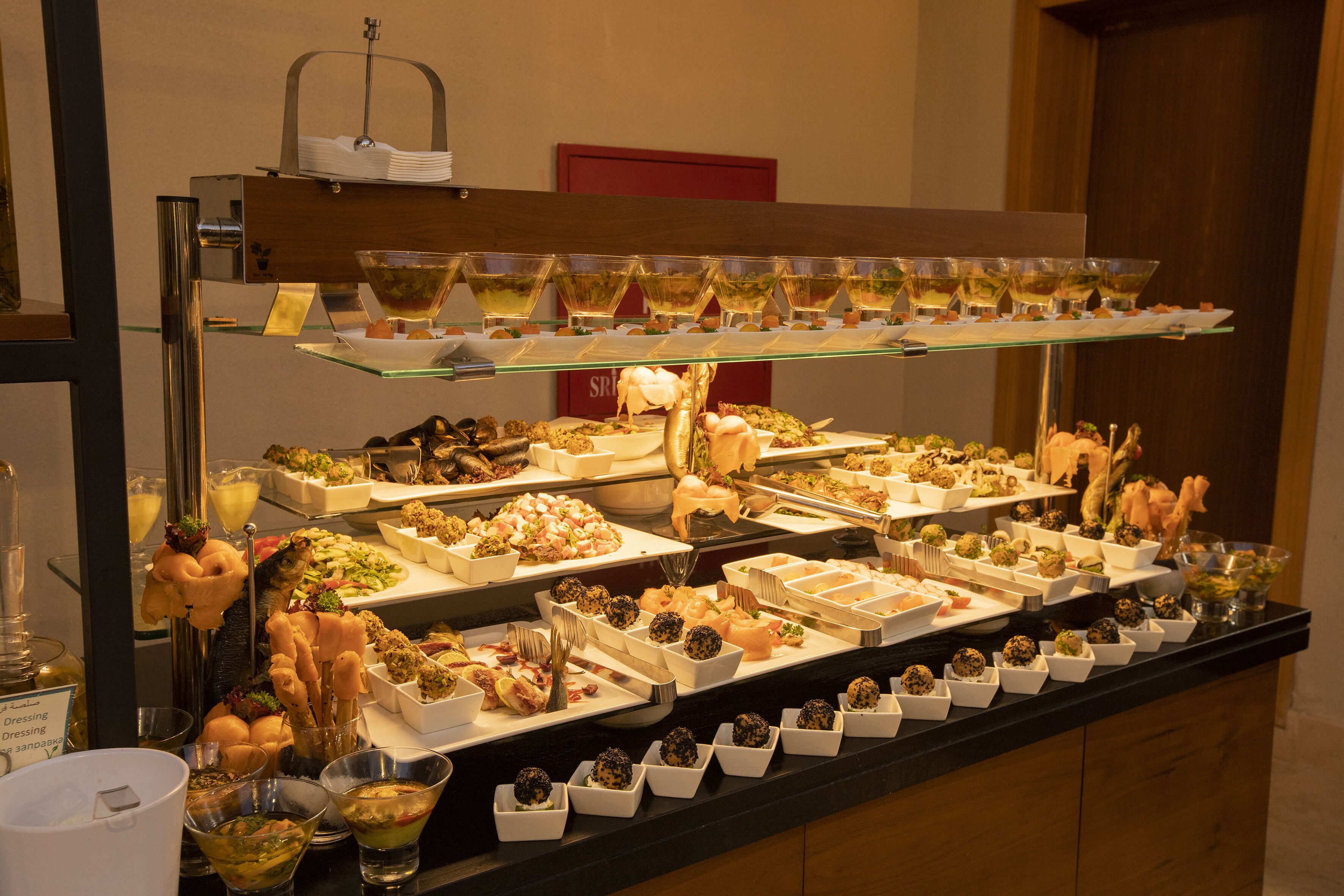 A buffet with various dishes and drinks.