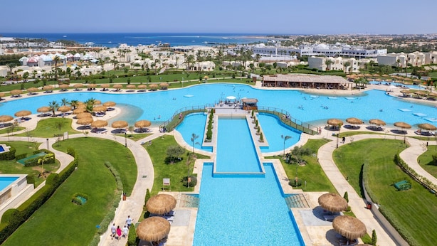 An aerial view of a resort with a central swimming pool, multiple smaller pools, and a beach area. - Xanadu Makadi Bay - High Class All Inclusive (Makadi Bay)