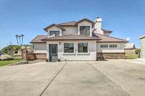 A two-story house with a brick facade, a tiled roof, and a front entrance with a door and windows. - 2 Mi to Dtwn Gilbert! Snowbird Escape w/ Pool (Gilbert)