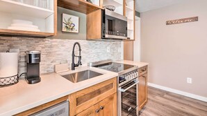 A modern kitchen with a Keurig coffee maker, stainless steel sink, and built-in oven. - Short Drive to State Parks: Herber City Apt (Heber City)
